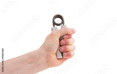 Male hand exercising grip strength using a metal hand gripper