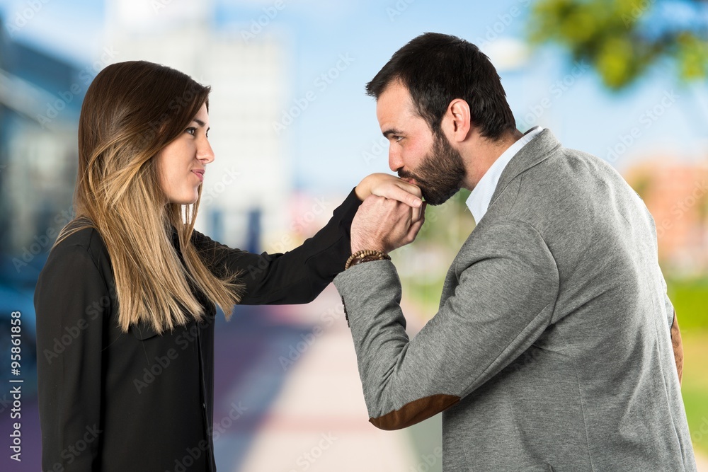 man kissing a woman's hand over white background. man kissing a woman's hand over white background.