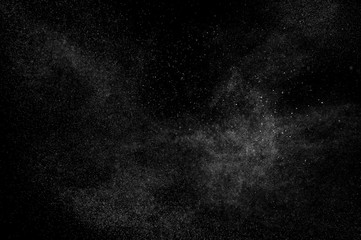 Water spray with droplets and particles on black background