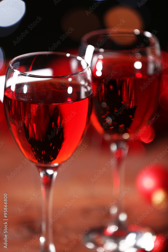 Wine glasses with Christmas decorations on wooden table, close up Wine glasses with Christmas decorations on wooden table, close up