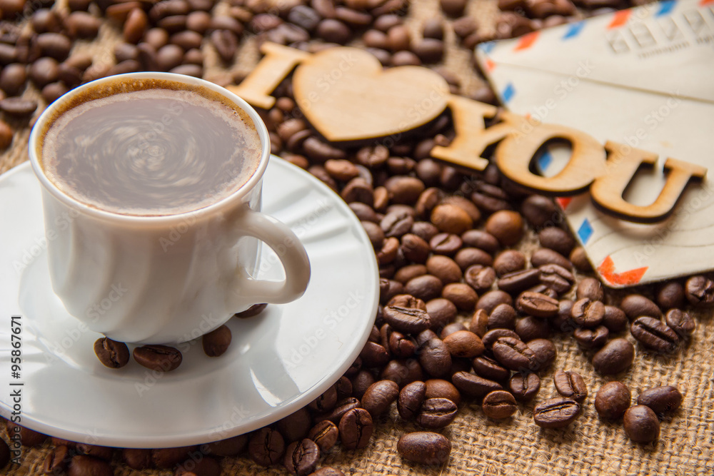 Fototapeta premium cup of coffee and a letter on the table