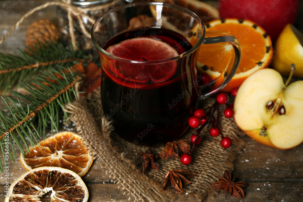 Beautiful Christmas composition of mulled wine on decorated wooden table, close up Beautiful Christmas composition of mulled wine on decorated wooden table, close up