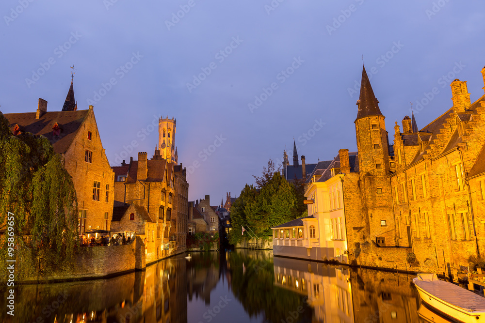 Image of Rozenhoedkaai at dusk in Bruges,Belgium with belfry tow