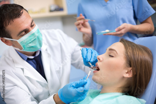 Dentist put dental stopping to a patient