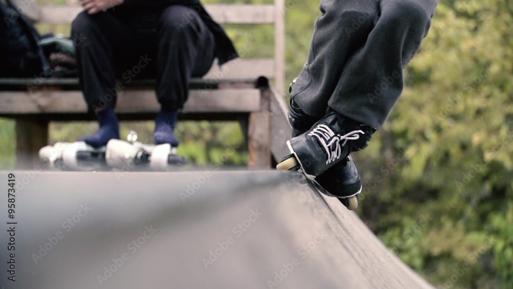 Teen with roller skates performing a stunt on a half pipe ramp Slow Motion 400 fps Teen with roller skates performing a stunt on a half pipe ramp Slow Motion 400 fps