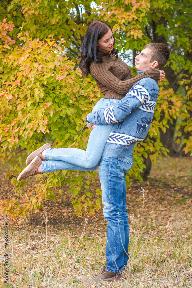 girl at the hands of Man. A loving couple walking in the autumn girl at the hands of Man. A loving couple walking in the autumn