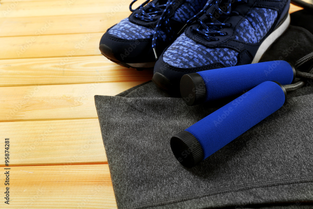 Sport clothes and equipment on wooden background Sport clothes and equipment on wooden background