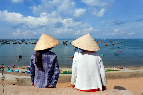 Vietnamese woman in fisherman village sitting in sunshine backgr