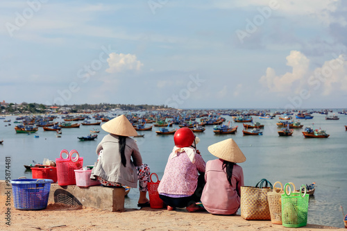 Vietnamese woman in fisherman village sitting in sunshine backgr