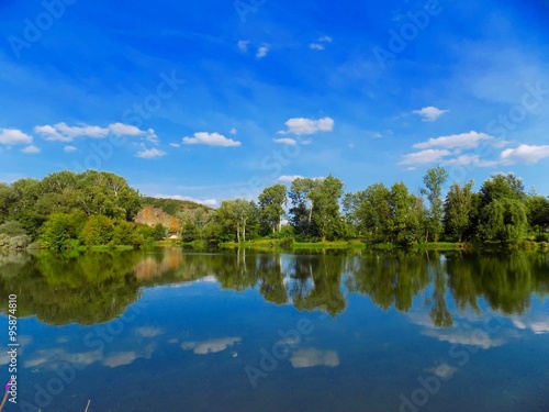 Lake with reflexion, trees and sky