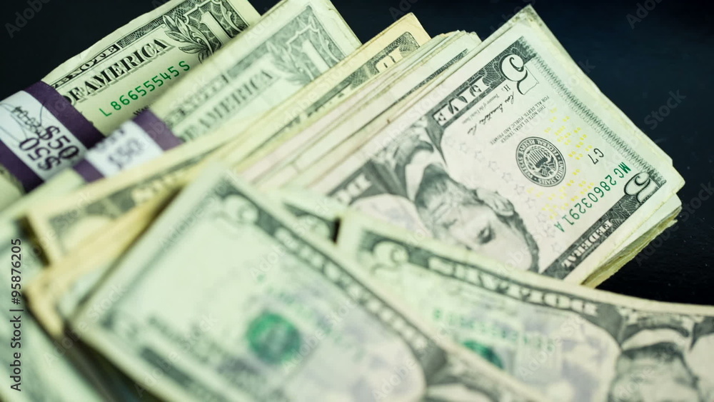 Moving Over Thrown Money Stack. camera moves over area as a stack of money is thrown in. fives and one dollar bills
Moving Over Thrown Money Stack. camera moves over area as a stack of money is thrown in. fives and one dollar bills
