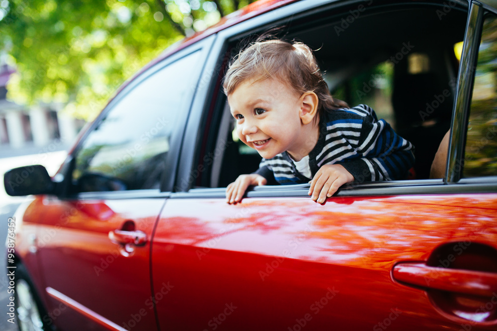 Baby boy in the car looking throw window. Baby boy in the car looking throw window.