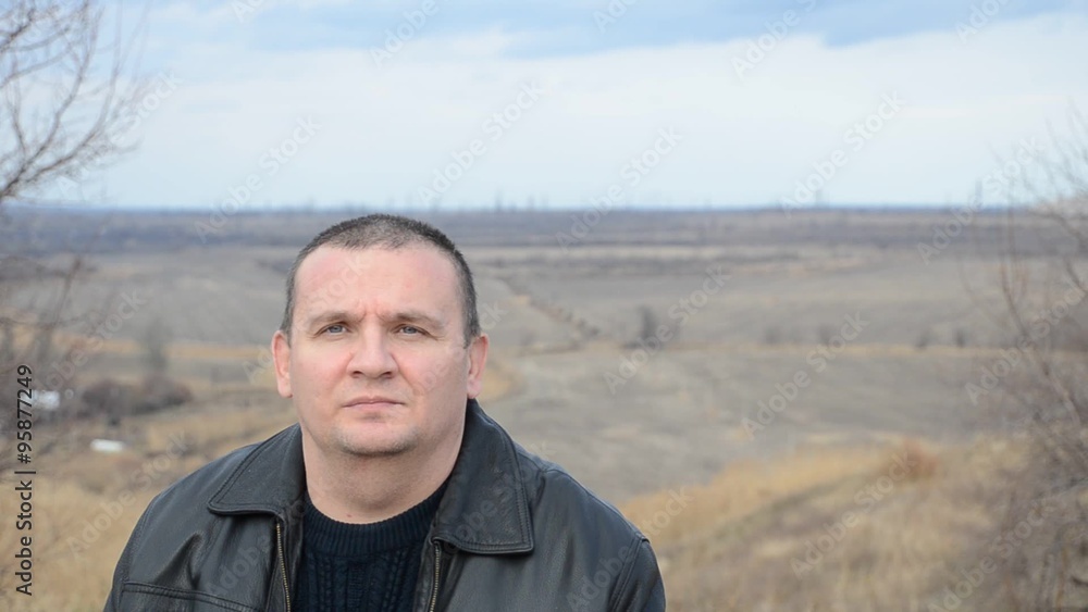 Portrait of a man against the backdrop of autumn fields Portrait of a man against the backdrop of autumn fields