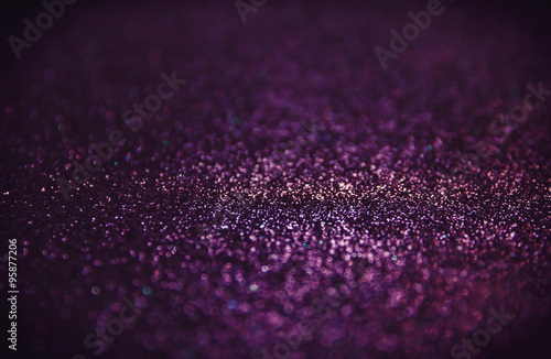 abstract glitter purple lights background 