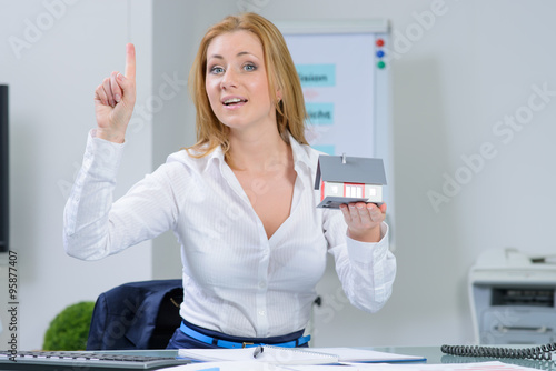 beautiful woman at office dreaming about  home photo