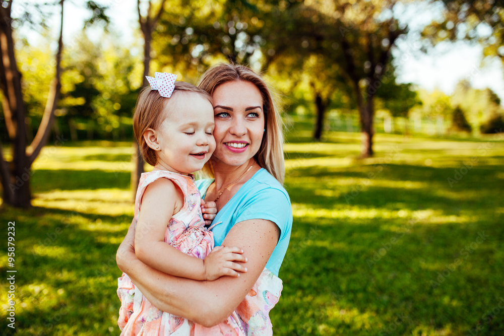 Happy mom and daughter smiling at nature. Happy mom and daughter smiling at nature.