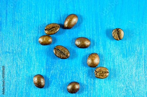 Coffee beans isolated on wooden background photo