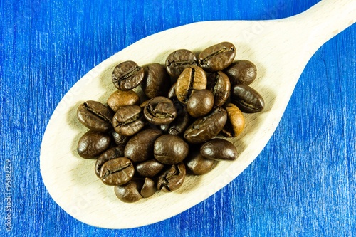 Coffee beans in wooden spoon photo