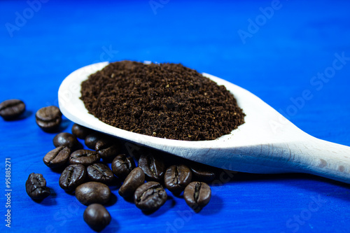 Ground coffee on wooden spoon photo