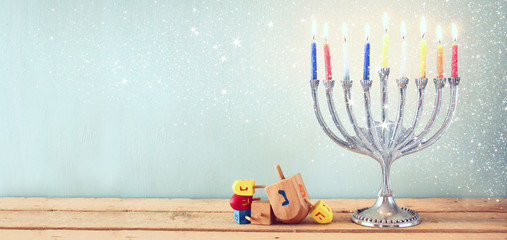 website banner image of of jewish holiday Hanukkah with menorah (traditional Candelabra). retro filtered.