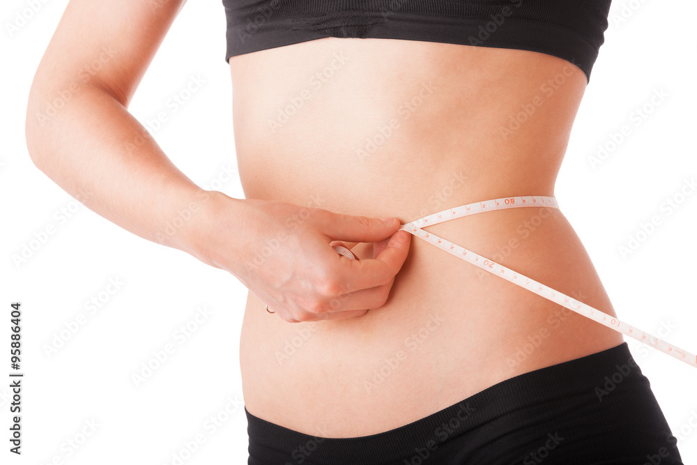Slim girl measuring her waist by meter Slim girl measuring her waist by meter