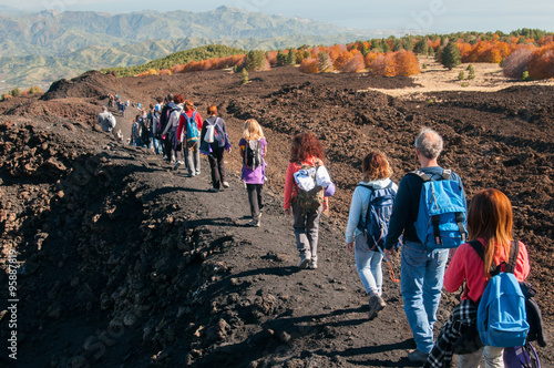 Group of hikers walking on a trail on to the north side of Mount Etna