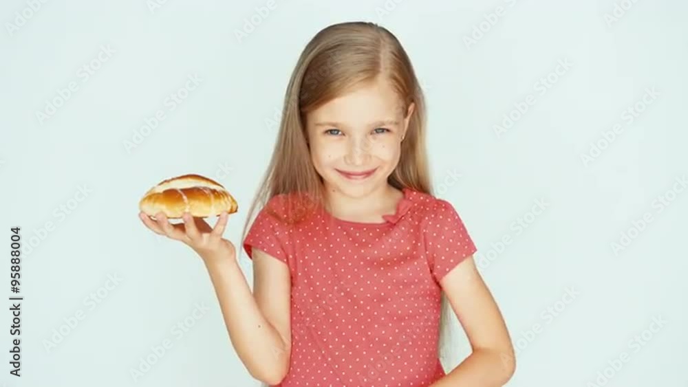 Girl holding a cake with cheese. Child rubs his belly. Child on the white background Girl holding a cake with cheese. Child rubs his belly. Child on the white background