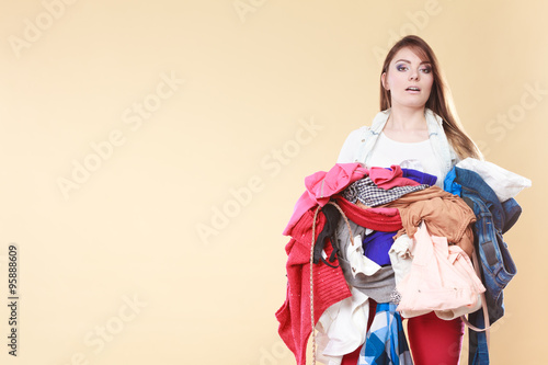 Woman carrying dirty laundry clothes.
