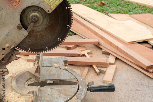 Electric circular saw/Close up, electric circular saw cutting planks.