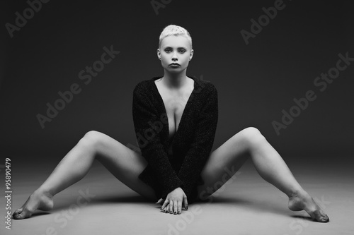 Beautiful young woman sitting with legs spread