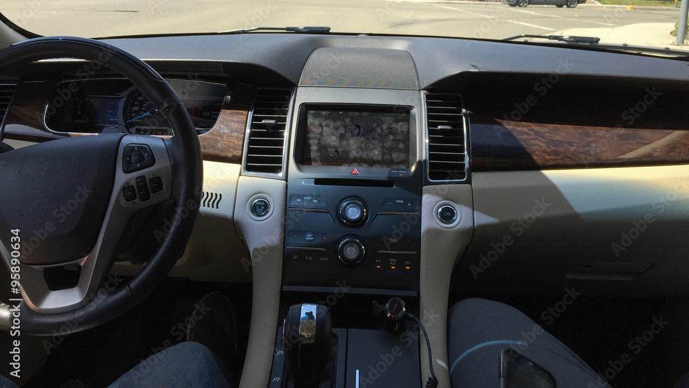 Badly stained with fingerprints touch screen of modern car control display in its dashboard