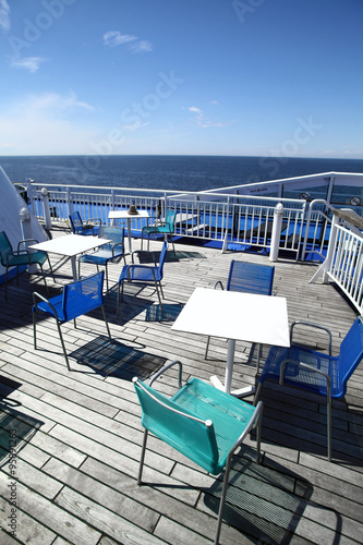 Chairs and tables on a ferry deck © bizoo_n