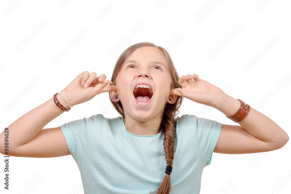 Stressed young girl covers ears with hands on white background