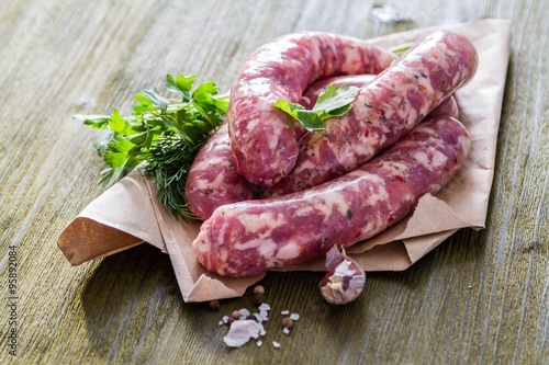 Raw sausages with herbs and spices