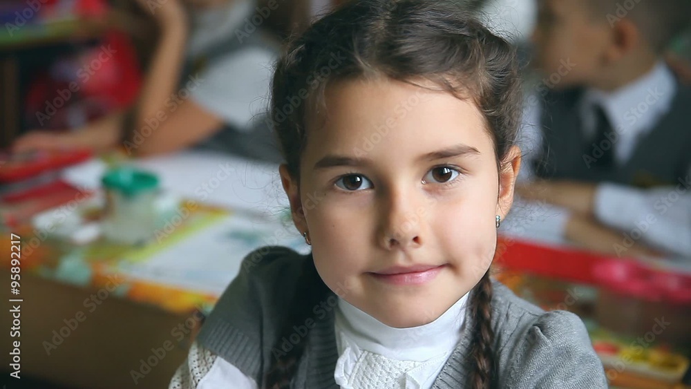 teen portrait girl sitting at a desk in school classroom teen portrait girl sitting at a desk in school classroom