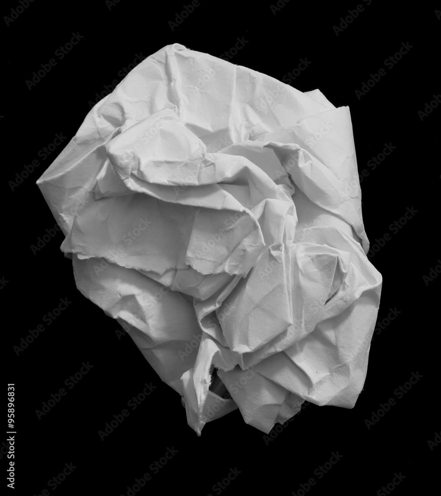 A crumpled paper ball in a black background
