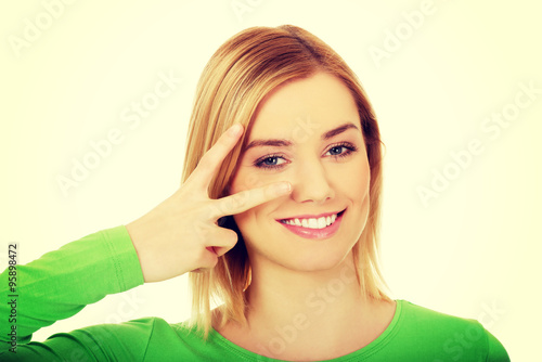 Woman showing victory sign.