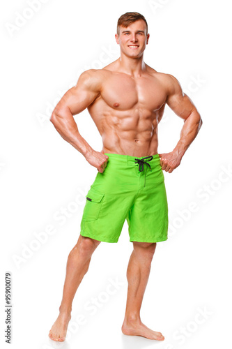 Sexy athletic man showing abdominal muscles without fat, isolated over white background. Muscular male fitness model abs © nikolas_jkd