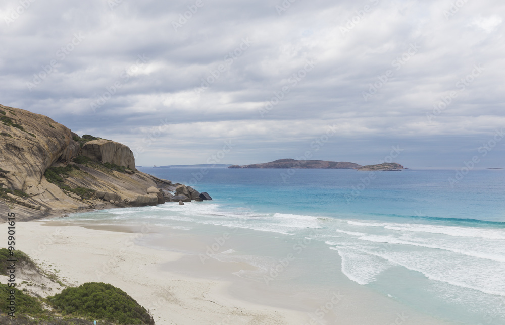 West Beach with White Sand and Turquoise Blue Water under a Cloudy Sky