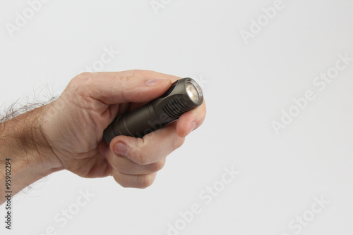 hand holds included a small flashlight on a white background
