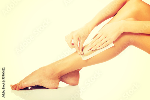 Woman waxing her leg