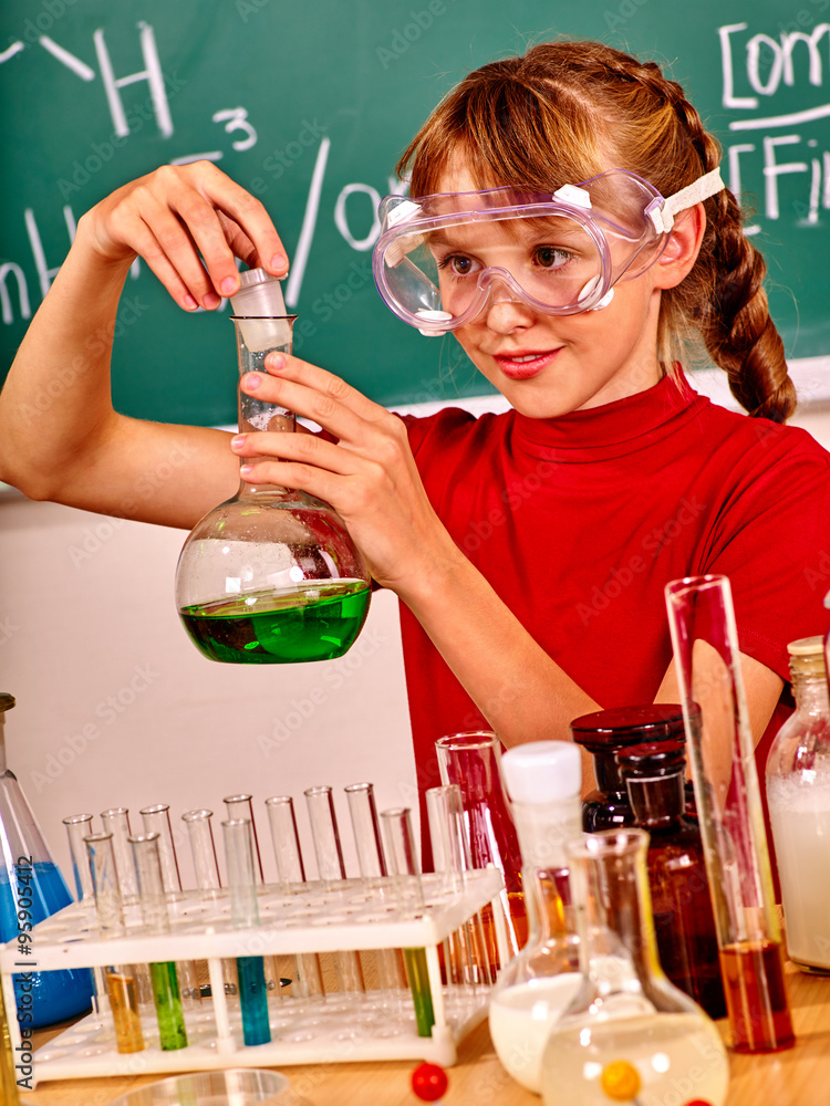 Child in chemistry class. Child in chemistry class.