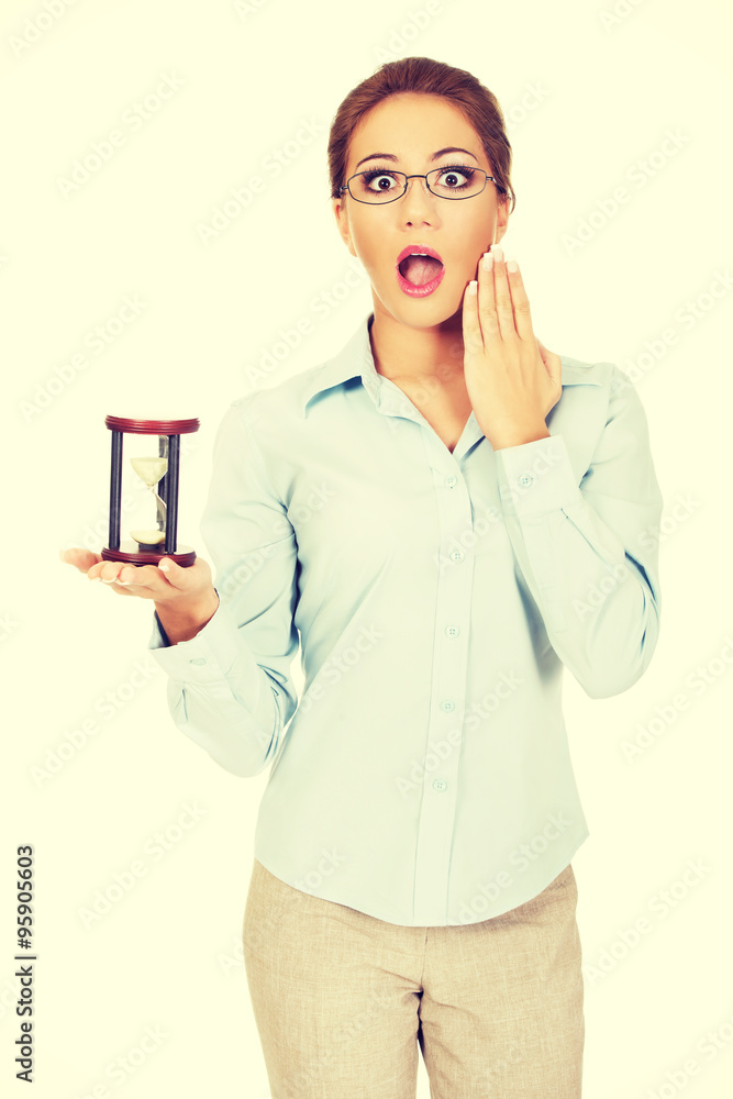 Young businesswoman with hourglass. Young businesswoman with hourglass.