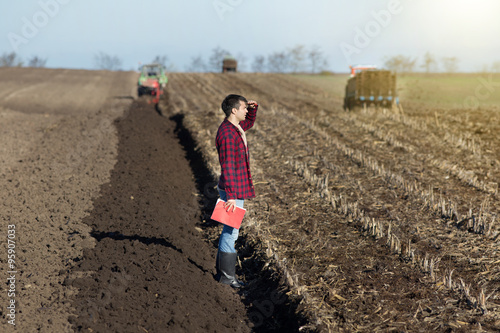 Farmer with tractors on field photo