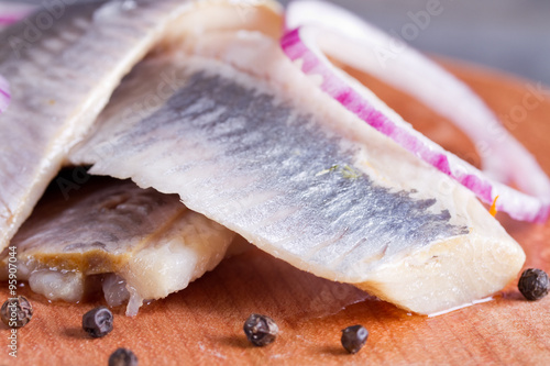 Pieces of herring fillet on a cutting board