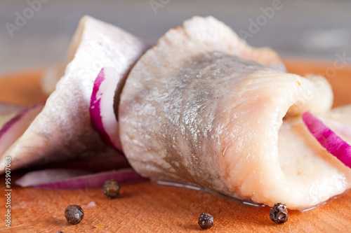 Pieces of herring fillet on a cutting board photo