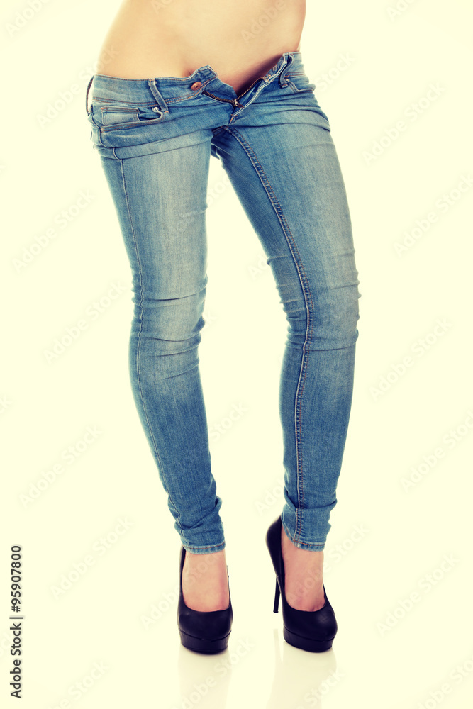 Female legs in jeans and high heel shoes. Female legs in jeans and high heel shoes.