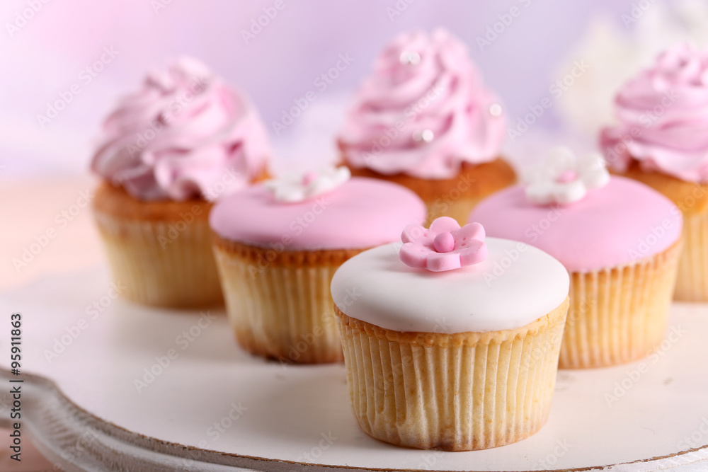 Tasty cupcakes on stand, close-up