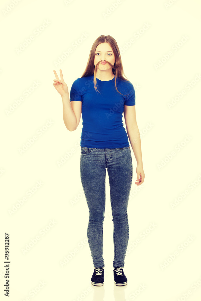 Teenager making moustache from hair. Teenager making moustache from hair.