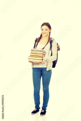 Beautiful teenager with backpack and books. © Piotr Marcinski